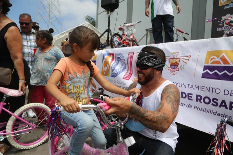 The look on Rolling Deep’s Ram Casillas’s face as he gives a lucky girl a bicycle says it all. One of dozens of bicycles given away to the children of Rosarito.