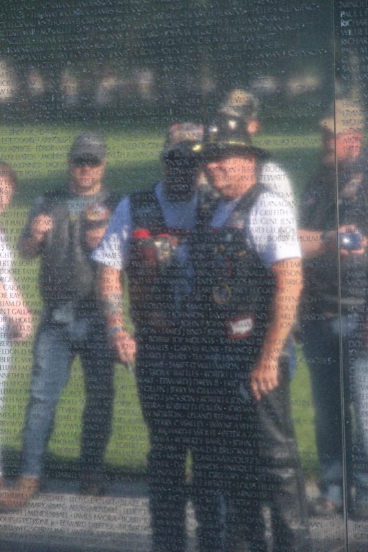 Two Vietnam Vets reading the names of their lost comrades