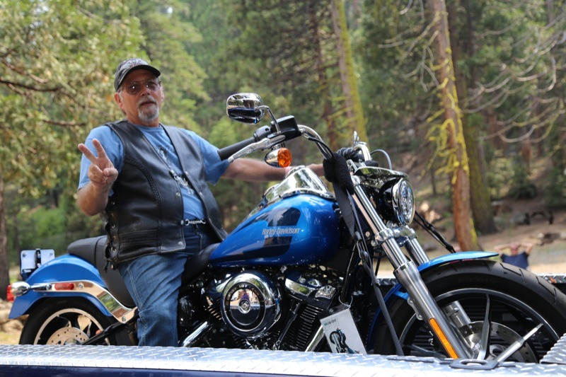 Ron Easton from Crystal Falls was overjoyed when his ticket was called for the grand prize which was an Electric Blue 2018 Softail Low Rider