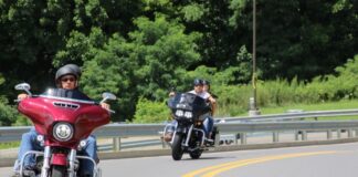 Bikers riding up the hill on the way into the festival