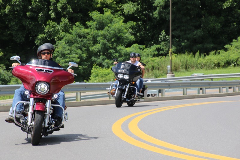 Bikers riding up the hill on the way into the festival