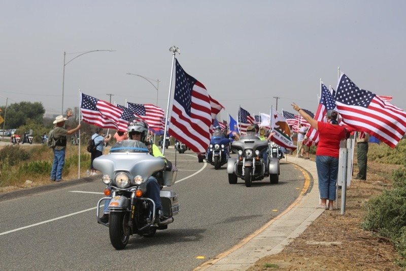 Boy Scouts, along other volunteers lined the path holding flags and cheering on the procession