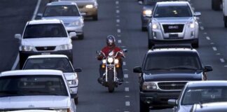 A motorcyclist splits lanes in California, the only state where it is currently legal.