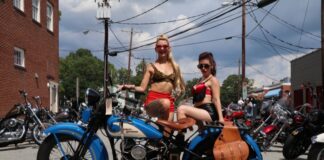 A pair of Burlesque dancers take a break to pose on my 1933 Harley-Davidson VL while handing out flyers during the Bull City Rumble