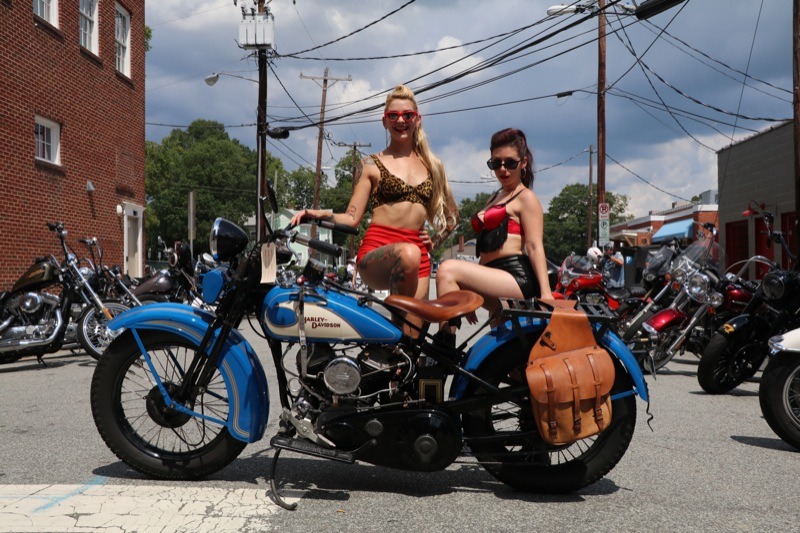A pair of Burlesque dancers take a break to pose on my 1933 Harley-Davidson VL while handing out flyers during the Bull City Rumble