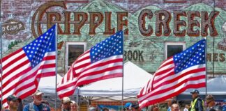 Volunteer honor guards bearing US Flags at the POW/MIA Ceremony in downtown Cripple Creek, Colorado