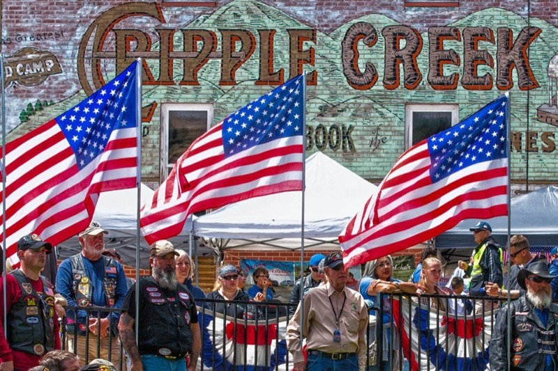 Volunteer honor guards bearing US Flags at the POW/MIA Ceremony in downtown Cripple Creek, Colorado