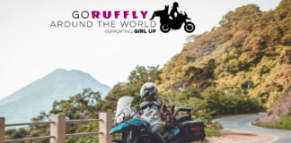 Jess Stone and Moxie on a motorcycle with World Adventure logo
