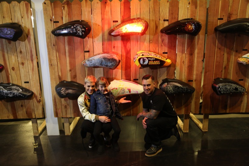 Carey Hart is joined by his wife, Pink, and their daughter Willow, for a picture in front of Willow’s custom tank. The tank ended up raising $7,600, more than any other tank in the auction.