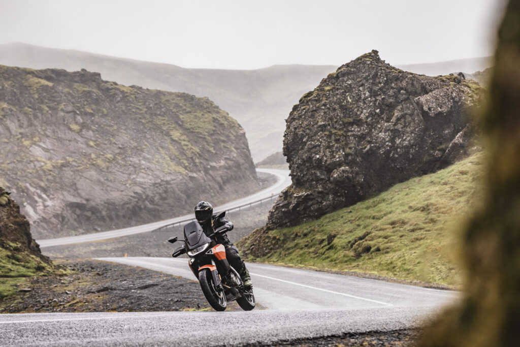 Norton Atlas cornering on a winding road during a motorcycle test