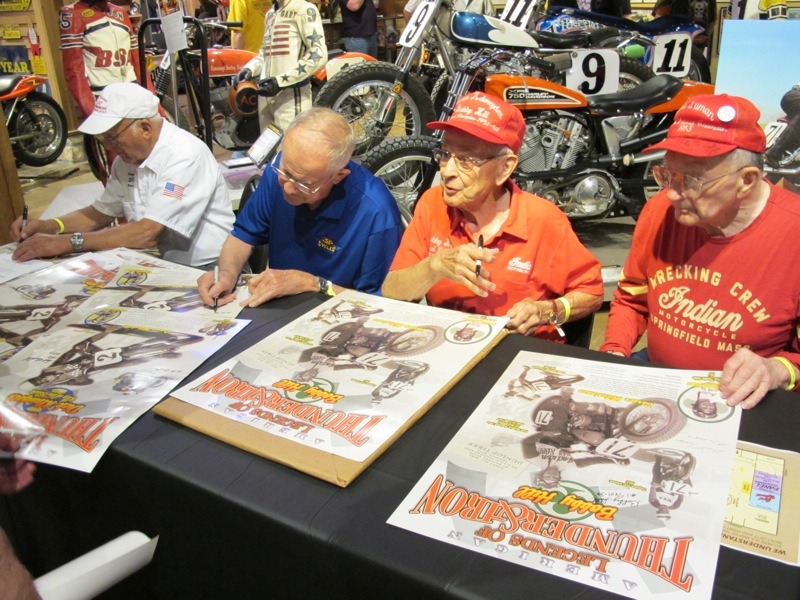 Racing legends Dick "King of the Beach" Klamfoth (far left), Bill Baird, Bobby Hill and Bill Tuman sign posters in the Dirt Track Heroes exhibit