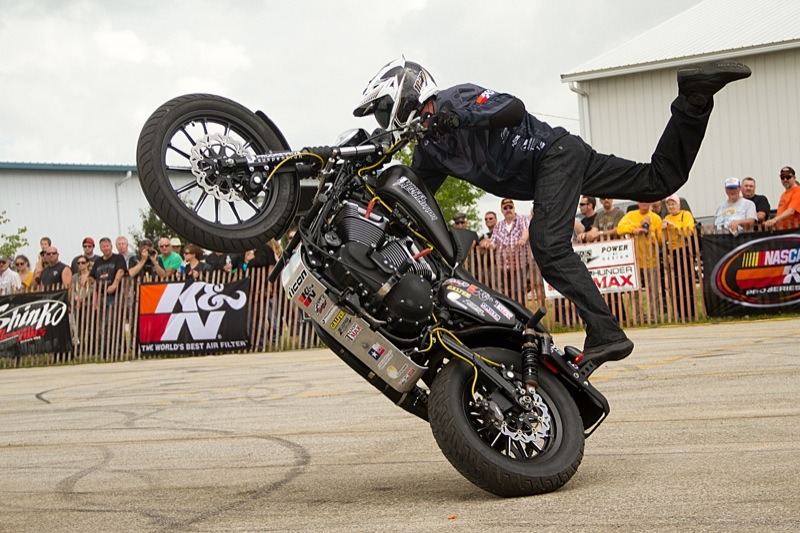 Rob Carpenter from 1 Wheel Revolution performs a stand-up circle wheelie on a Sportster