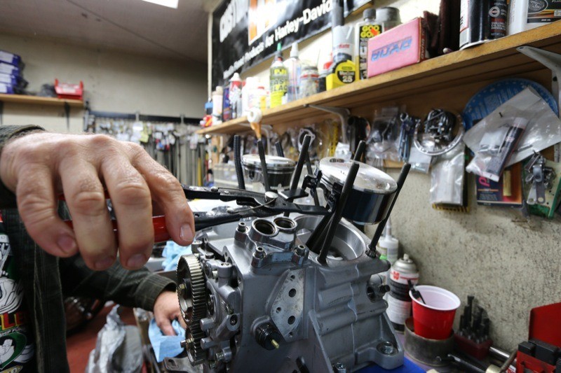 After the rings are installed, Ken uses the K-D Piston Ring Compressor Tool to compress the rings, allowing the cylinders to be slipped over them