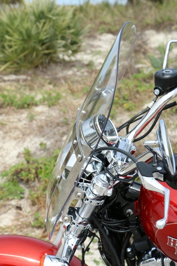 The quick-detach windshield uses lever-release clamps and can be adjusted to match the rider's height
